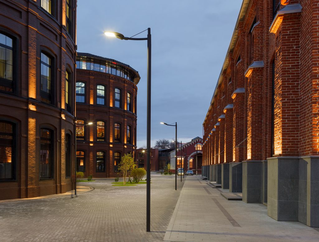 Office complex exterior in loft style. Street lamps and Evening illumination Office complex exterior in loft style. Street lamps and Evening illumination